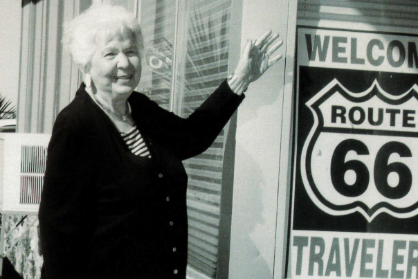 Black and white photograph of Bettie Ditto outside Best Western Pow Wow Inn.