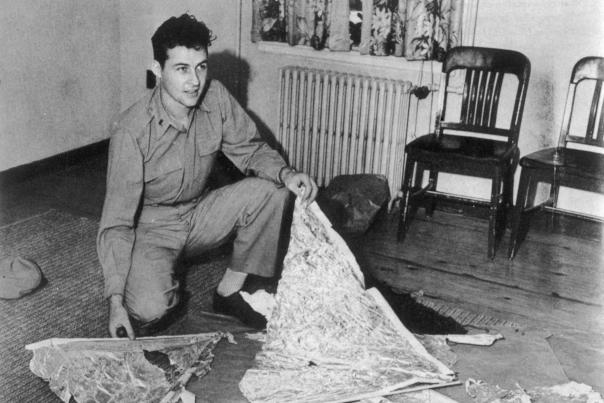 Air Force officer Irving Newton holds debris from the 1947 crash.