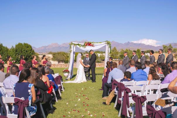 Outdoor wedding ceremony under a bright blue sky.