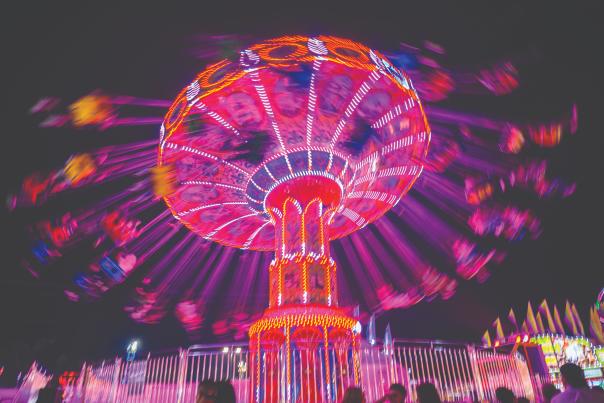 The Wave Swinger lights up the midway at the New Mexico State Fair.