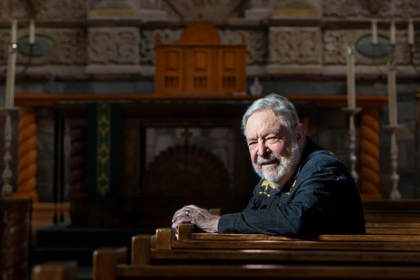 David Policansky sits in the pews of Santa Fe's Cristo Rey Catholic Church, which features a hand-carved altarpiece from the 1760s.