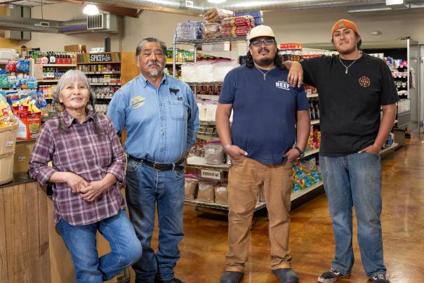 Four members of the Tsabetsaye family standing inside Major Market in Zuni Pueblo.