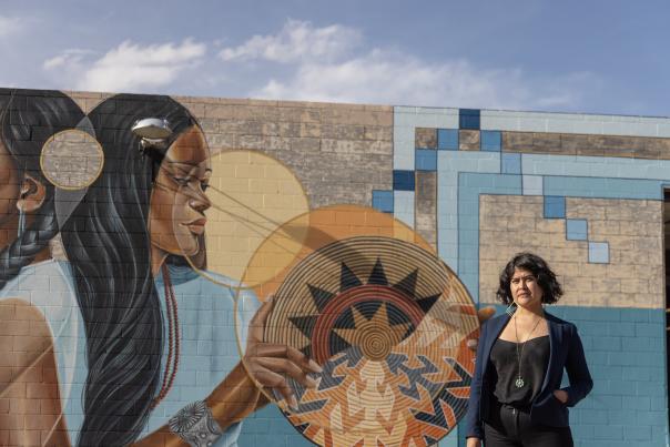 Nani Chacon stands outside mural