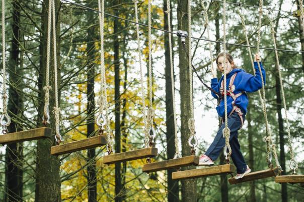 Girl crossing the Tree Top at The Jungle NI