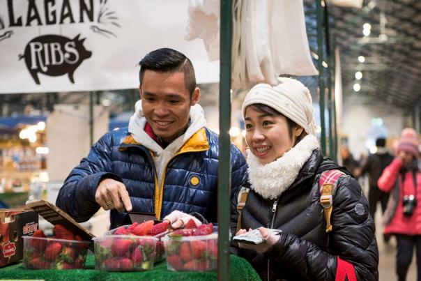Couple with tour guide at St. George's Market with Belfast Food Tours