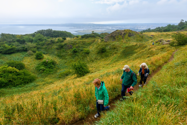 A group walks along the trail at Cave Hill