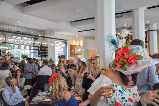 Photo of women in hats at a derby day party at coppins at hotel covington