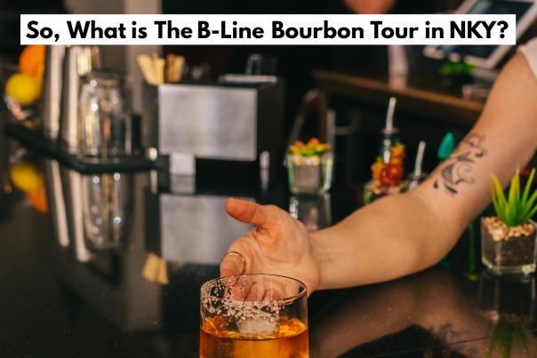 A woman's hand offering an old fashioned on a glossy bar with the words "So, What is The B-Line Bourbon Tour in NKY" printed above.