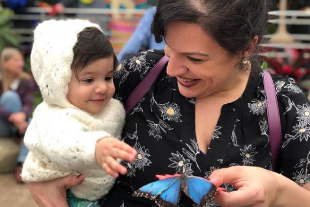 mother and child holding blue butterfly at krohn conservatory butterfly show in cincinnati oh