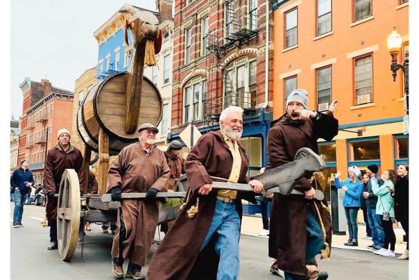 People dressed as monks pulling a huge wooden goat in Cincinnati's Bockfest parade