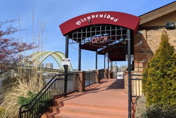 exterior photo of cancun mexican restaurant and bar with photo of big mac bridge in background over the ohio river in newport ky and cincinnati oh