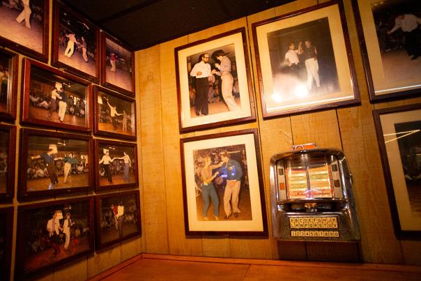 A photo of a Shag Wall of Fame and an old jukebox located inside Fat Harold's