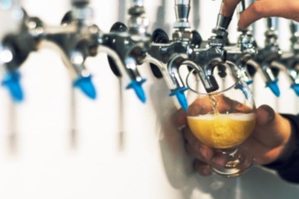 Beer being poured from taps in the wall