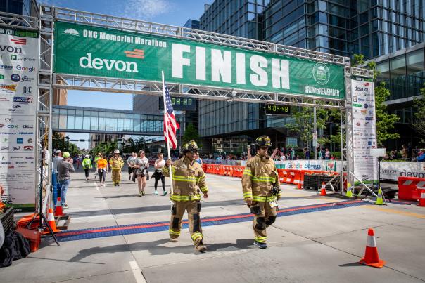 Firefighters carrying an American flag across the finish line of the OKC Memorial Marathon