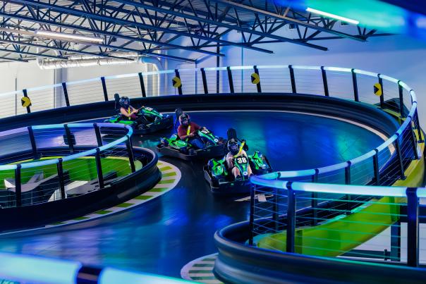 Cars racing at Andretti Indoor Karting & Games