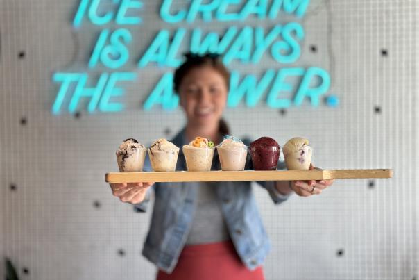 Woman holding ice cream flight at Boom Town Creamery