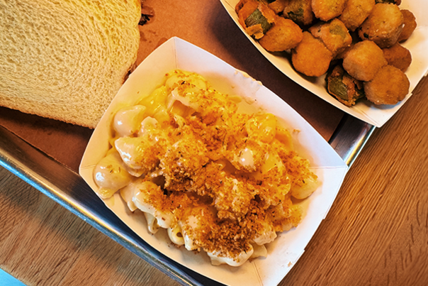 Mac & Cheese, a slice of bread and fried okra sitting on a table