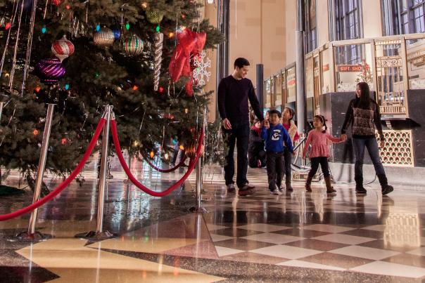 A family walks by the huge Christmas tree on display at the Durham Museum in Omaha, NE.