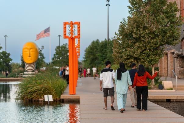 People walking by a water feature at the Gene Leahy Mall at The Riverfront.