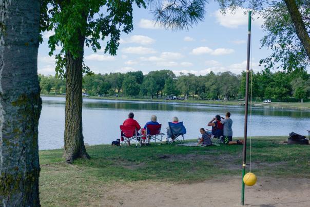 A family sitting beside Memphis Lake.