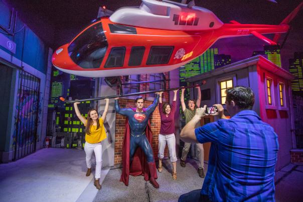 Group poses with Superman at Madame Tussauds