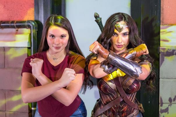 Woman poses with Wonder Woman at Madame Tussauds