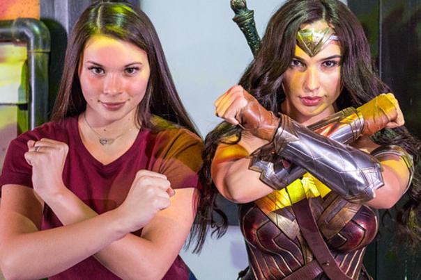 Woman poses with Wonder Woman at Madame Tussauds