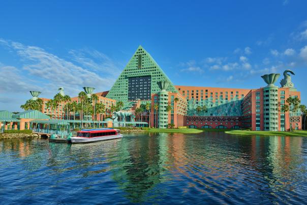 Exterior of Dolphin building and boat in water at Walt Disney World Swan and Dolphin Resort