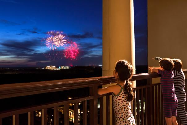 Four Seasons Resort Orlando at Walt Disney World® Resort children watching fireworks from balcony