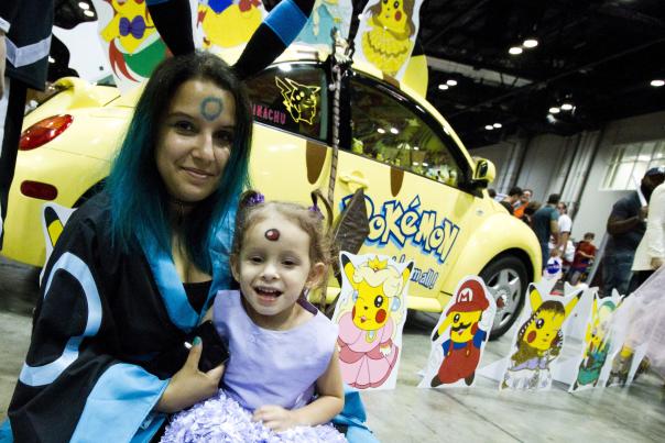 A woman and her child dressed up as Pokémon characters at MegaCon