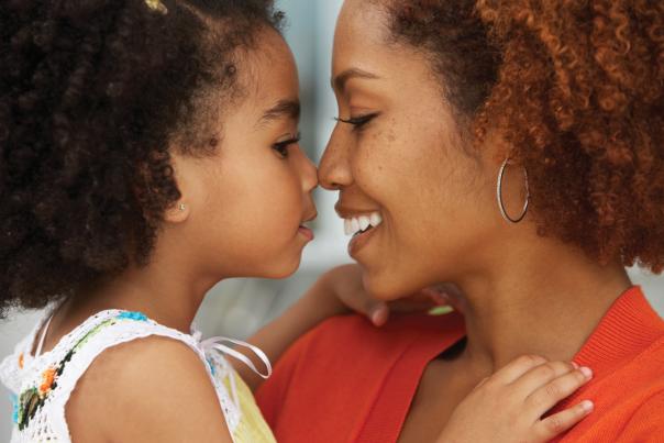 mother and daughter rubbing noses and smiling