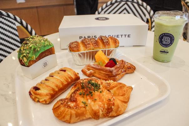 A tray full of pastries and an iced matcha latte from Paris Baguette