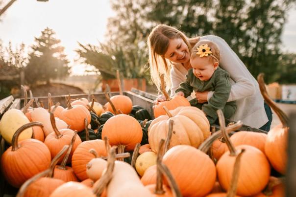 mom and baby with pumpkins