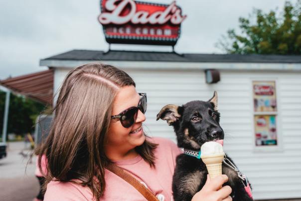 woman feeding ice cream to a dog