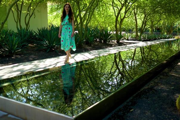 Woman walking near a reflection pool