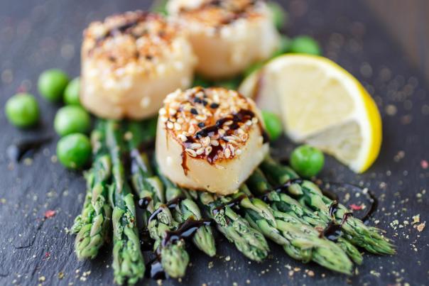 Seasoned scallops on a bed of asparagus