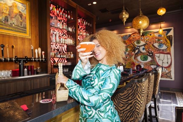 Woman with drink toasting