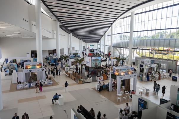 Panama Convention Center, a modern and spacious building with large windows and a sleek design.  It is located on the Amador Causeway, offering stunning views of the Pacific Ocean and the Bridge of the Americas.
