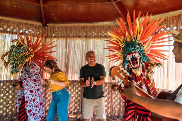 Group of tourists share with locals dressed in devil costumes in La Villa de los Santos