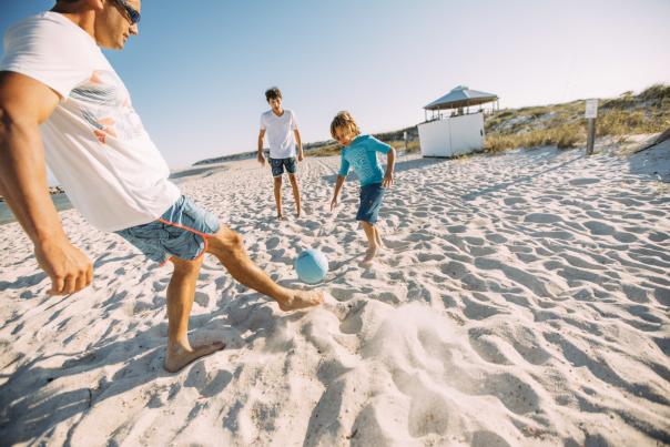 Family Beach playing soccer