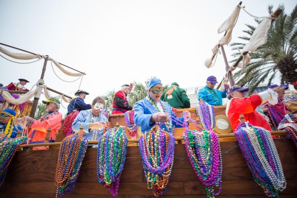 Festival goers organize beaded necklaces at the Panama City Beach Mardi Gras and Music Festival