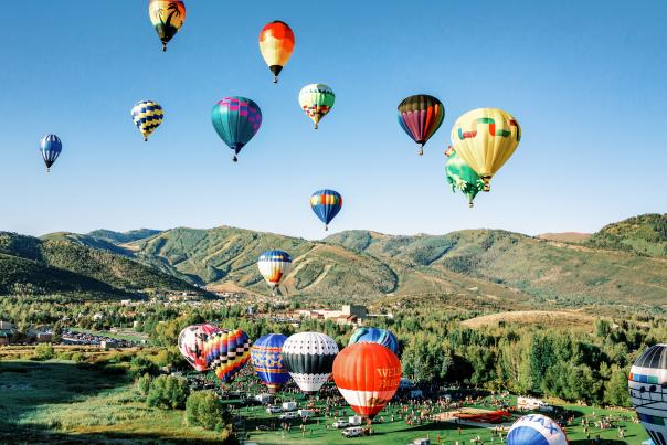 Group of Hot air balloons with scenic mountains in background