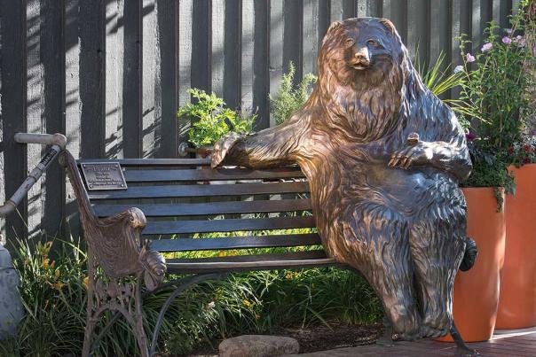 A statue of a bear on a bench on Main Street in Park City, UT