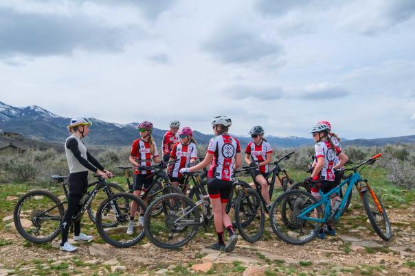 Haley Batten stands with the local Park City NICA girls team on a trail near Park City, UT