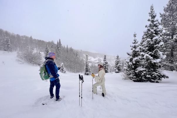 Guide and woman talking on historic snowshoe tour in Park City