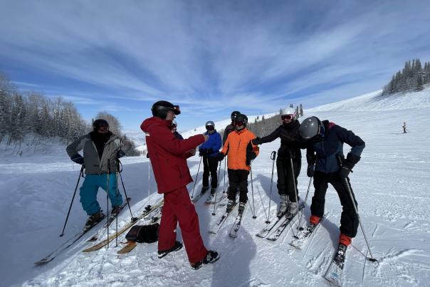 Group standing on their skis with guide of the Silver to Slopes tour.