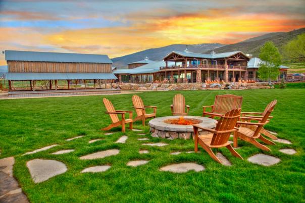 Chairs around a fire pit during sunset