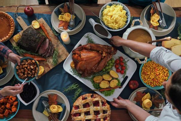 A turkey is served to a table surrounded by other Thanksgiving dishes in Park City, UT