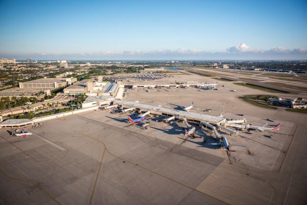Aerial view of Palm Beach International Airport with airplanes parked at gates.