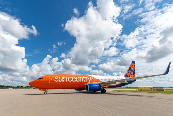 Sun Country Airlines aircraft parked on a runway at an airport